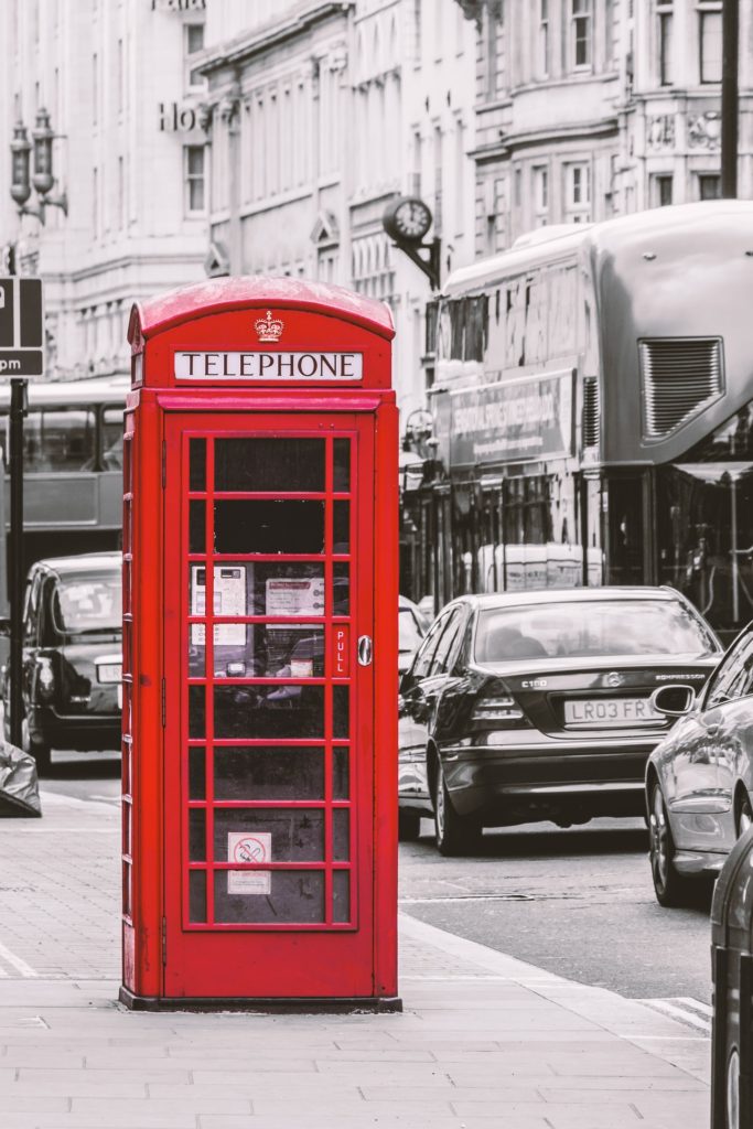 British spelling: Black and white photo of London streets with red telephone booth