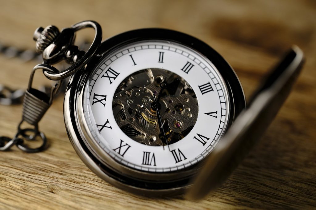 don't have time to write: an old-fashioned pocket watch rests on a table